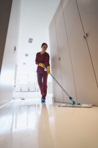 Focused experienced cleaner doing wet cleaning in apartment